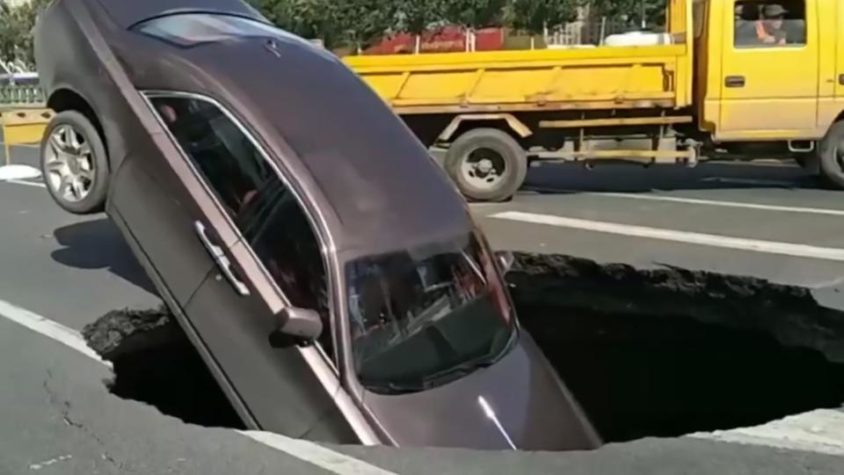 Rolls-Royce Owner Climbs Out After Car Gets Swallowed in Sinkhole